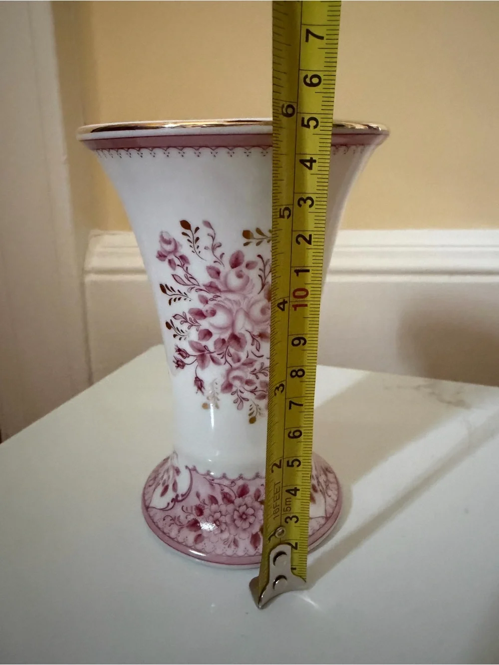 A vintage fluted vase w raspberry floral motif.